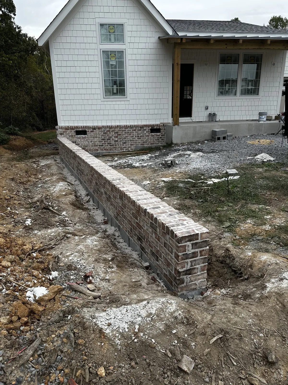 Finished brick retaining wall beside the home